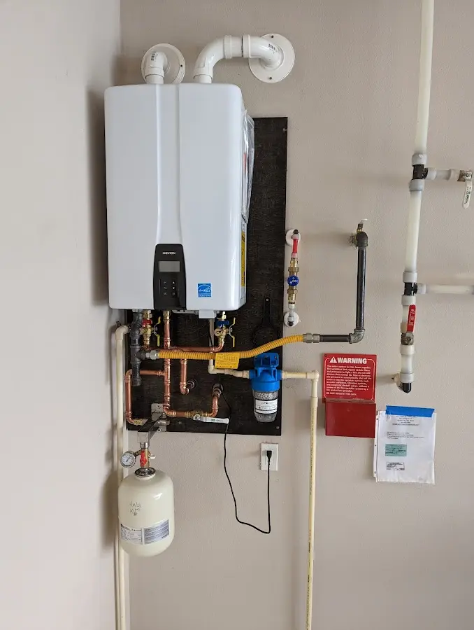Professional plumber installing copper piping in a Jamesburg home